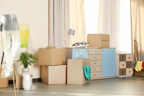 Packed moving boxes and furniture prepared for transport by Newham movers