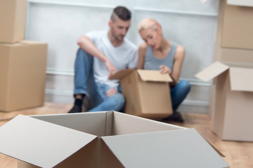Office relocation scene with movers carrying equipment in Newham