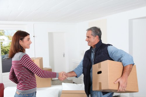 Professional movers navigating stairs during a Newham apartment move